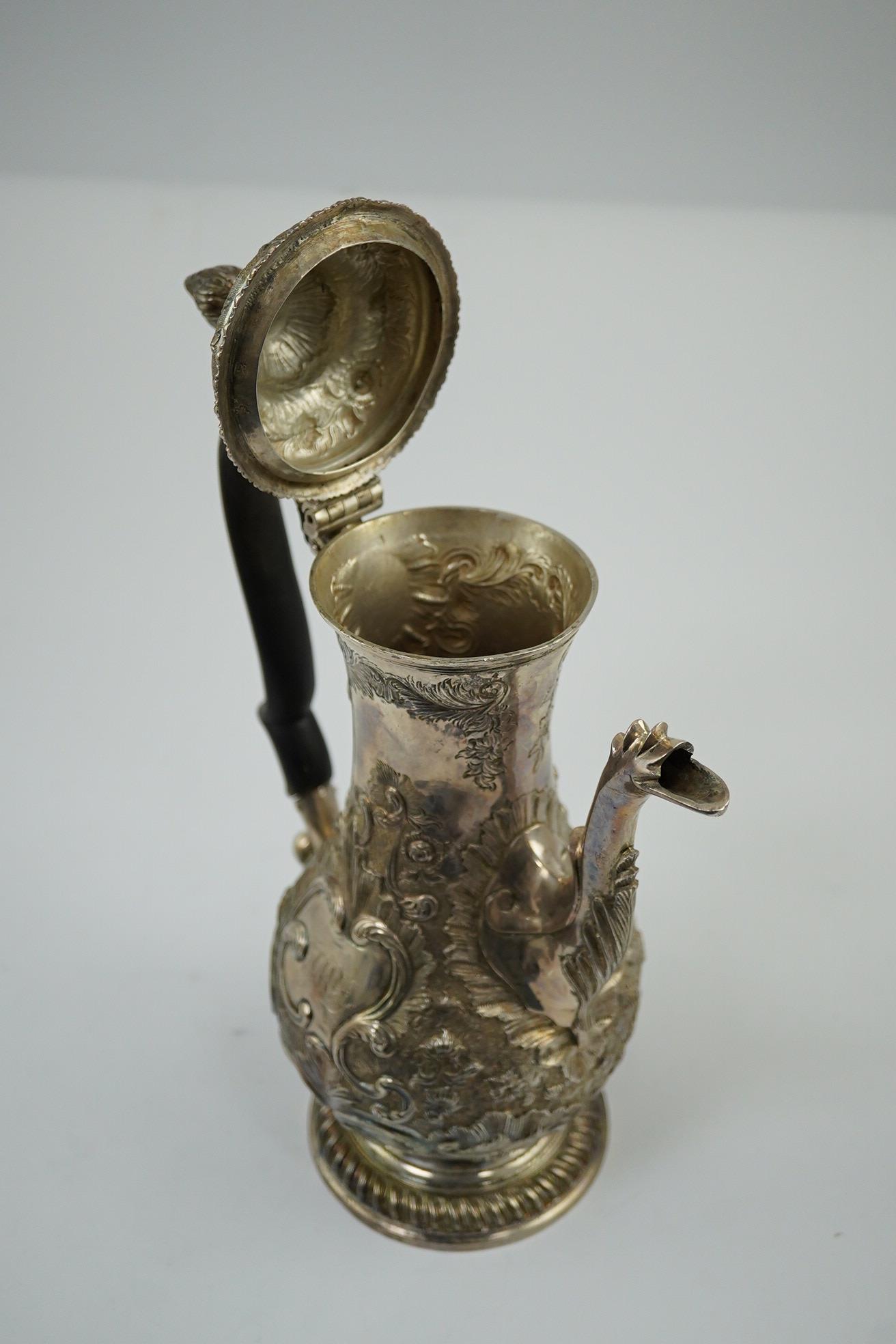 A George III silver coffee pot, by Aldridge & Green, with later embossed decoration